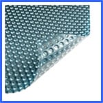 A sheet of translucent bubble wrap with a teal tint. The bottom right corner is slightly lifted, exposing the backside with raised bubbles. The background is white, and a blue border frames the image. | AES - Pool Heating & Energy Efficient Products