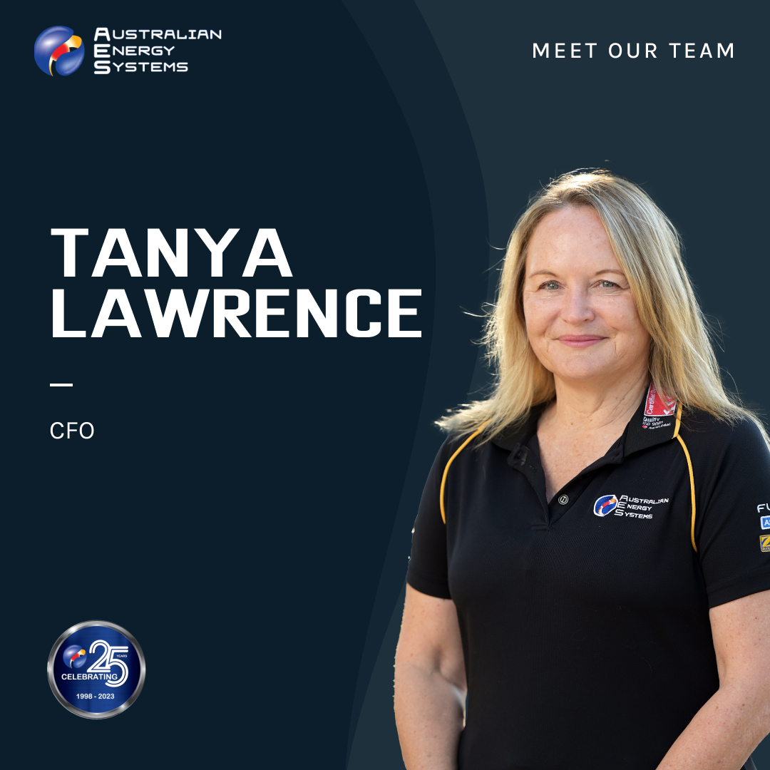 A woman with blonde hair, wearing a black polo shirt with embroidered logos, stands against a dark blue background. Text reads "Australian Energy Systems - Meet Our Team," with "Tanya Lawrence CFO" prominently displayed. A 25th-anniversary emblem is shown in the bottom left corner. Contact us for more details. | AES - Pool Heating & Energy Efficient Products